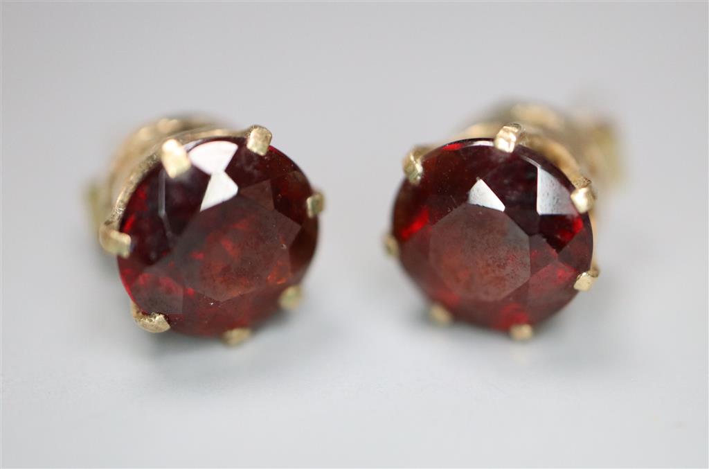 A pair of yellow metal and garnet set earstuds, gross 1.9 grams(a.f.).